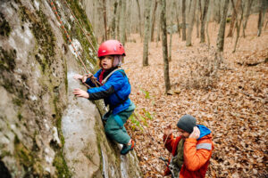 Child rock climbing with his father in Three Gorges